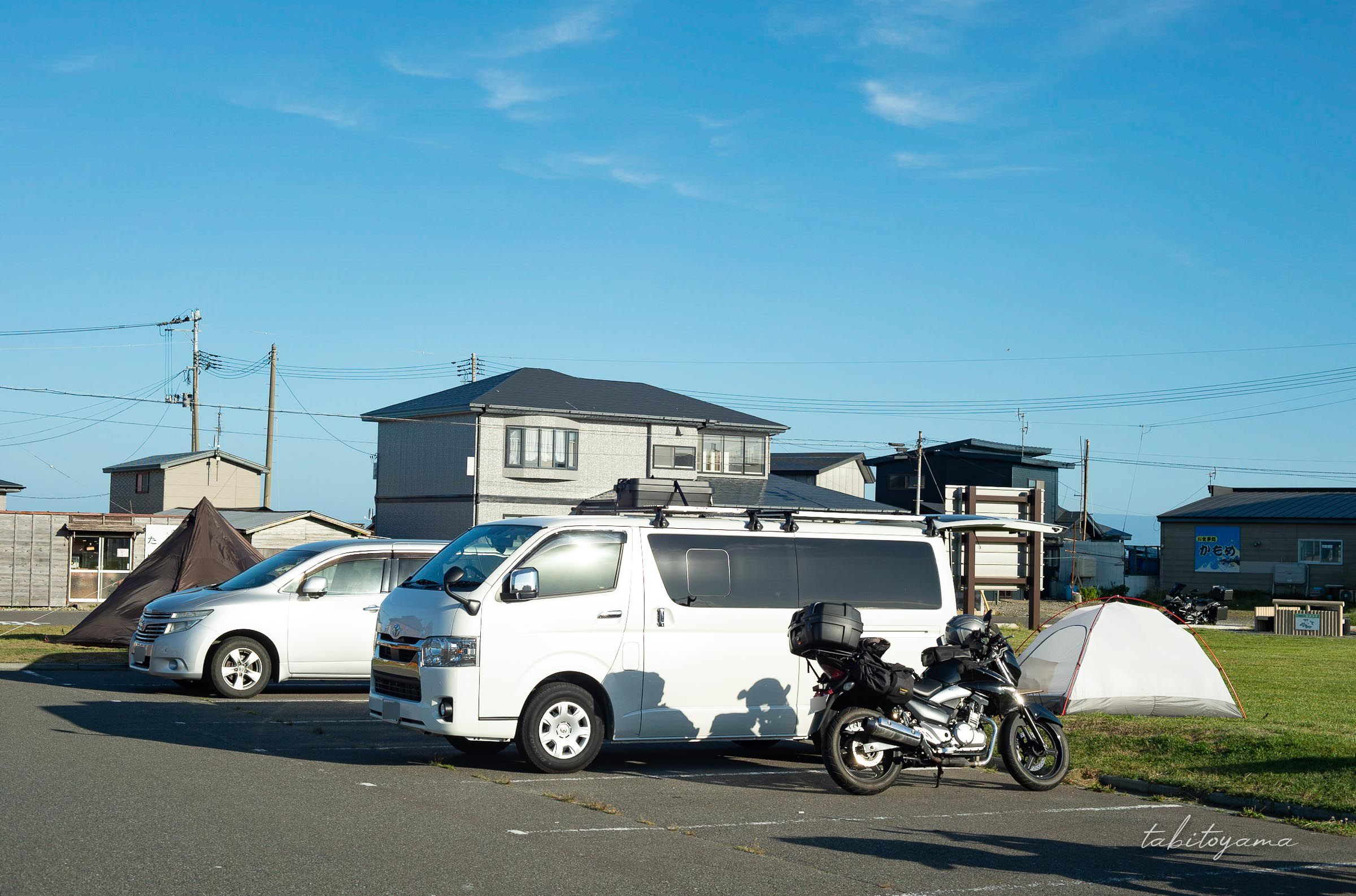 大間崎テントサイト駐車場に停まるバイクと車