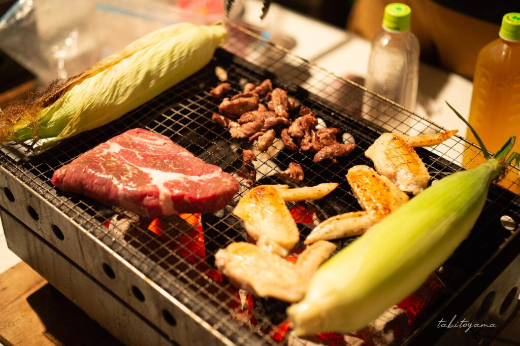 友人宅の庭の卓上コンロで焼かれる肉や野菜
